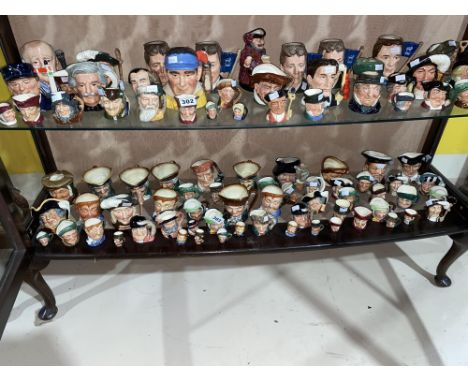 A shelf of medium, small and miniature Royal Doulton Character jugs
