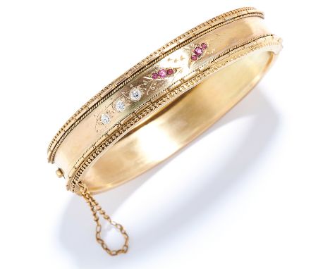 ANTIQUE RUBY AND DIAMOND BANGLE in yellow gold, set with round cut rubies and diamonds in engraved foliate motif, unmarked, 6