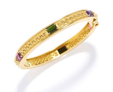 VINTAGE GEM SET BANGLE, VAHE NALTCHAYAN, 1986 in 18ct yellow gold, set with emerald cut tourmaline, peridot and amethyst, sig