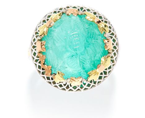 EMERALD DRESS RING in white and yellow gold, the circular carved emerald with gold floral accents, unmarked, size K / 5, 6.8g