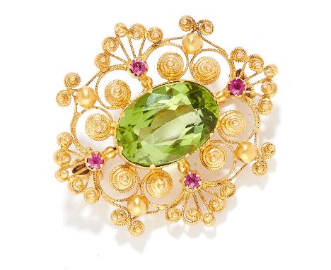 ANTIQUE PERIDOT AND RUBY BROOCH in 15ct yellow gold, set with an oval cut peridot and round cut rubies within scrollwork desi