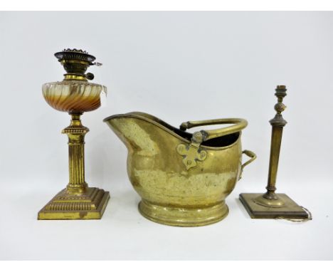 Early 20th century brass oil lamp base with Reg No 209074  together with a brass table lamp base and a brass helmet coal buck