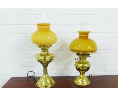 Two brass oil lamp style table lamps with amber coloured glass shades, (2)