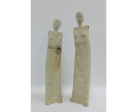 Pair of Art Pottery stoneware figures of elongated form, one with incised floral pattern and th other with ribbon pattern, on