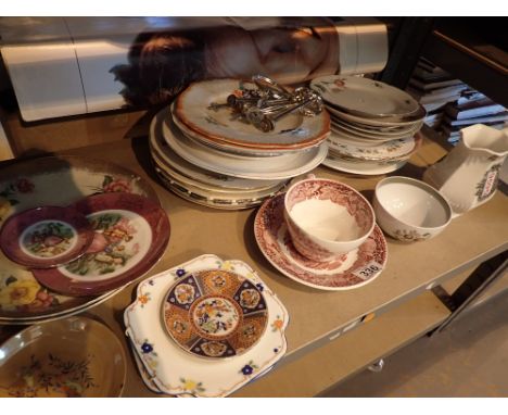 Shelf of mixed ceramics mainly plates 