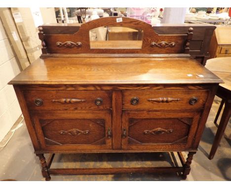 Antique oak sideboard with two drawers over two cabinets and a mirrored back panel