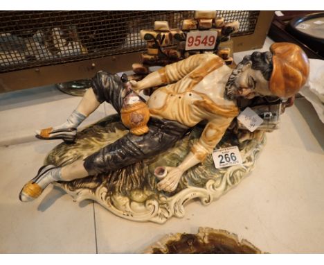 Figurine of drunken man on a bench