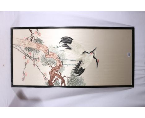 20th Century Chinese embroidered panel depicting two cranes amongst cherry blossom and pine branches, 98cm x 46cm and a pair 