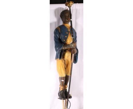 Painted composite lamp formed as a Blackamoor holding stick, 110cm tall 