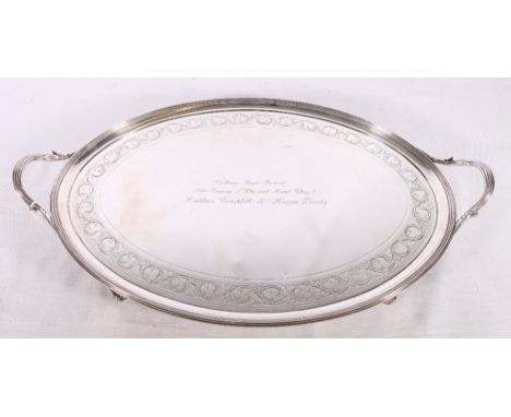 George III silver twin-handled tray with chased ivy band raised on four slender scroll supports, engraved "Caithness Music Fe