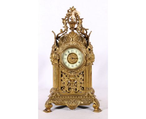 19th century gilded brass mantle clock with pierced sides having urn finial, 34cm tall  Clock has been over wound