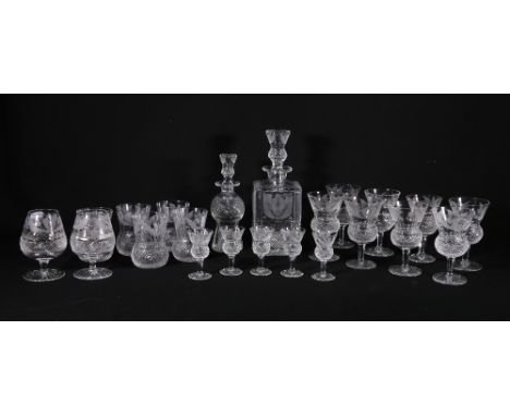 A twenty-two piece set of etched thistle and hobnail cut glassware including two decanters, set of eight wine glasses, five w