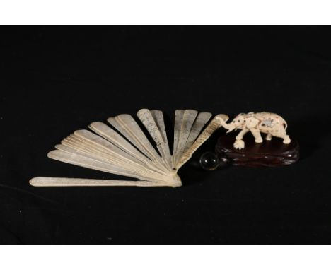 Japanese carved ivory model of an elephant with Shibayama inlay, a glass ball supported on its back (a/f) 10cm, wooden stand 