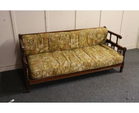 Early 20th century Arts and Crafts style oak framed sofa raised on square tapering supports terminating in spade feet, the cu