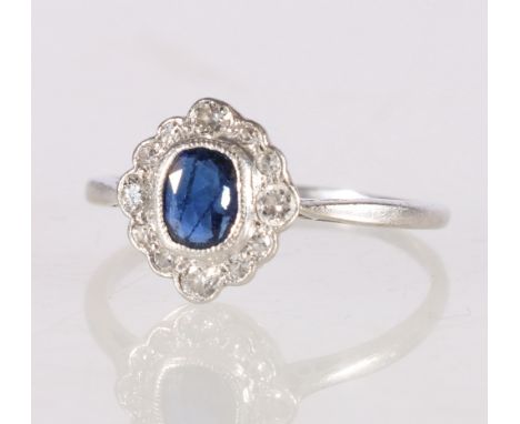 18ct platinum diamond and a sapphire ring, size P, 2.2g Condtion Report:Length x width x depth of the sapphire is 0.5cm x 0.4