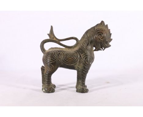 Indian bronze model of a lion with relief geometric decoration to the body, 20cm. 