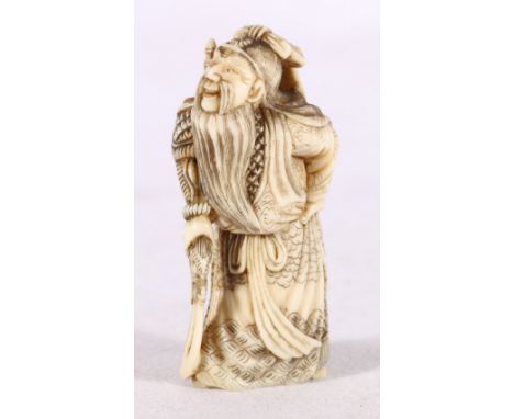 Japanese carved ivory netsuke or okimono depicting an elderly figure in traditional robes holding a sword, 5.5cm Meiji. 