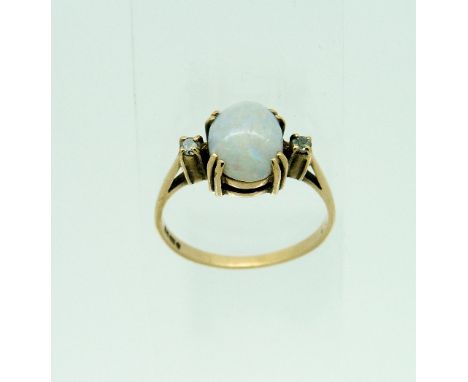 An oval opal Ring, with a small diamond on each shoulder, all mounted in 9ct yellow gold, Size L½.