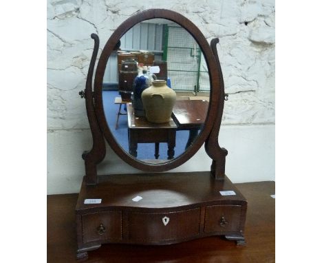 A Georgian inlaid mahogany oval Dressing-table Mirror, on serpentine front three drawer base.