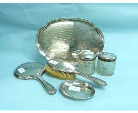 A George V silver near-matched six-piece dressing table set,  hallmarked Birmingham, 1911, 1913 and 1914, comprising an oval 