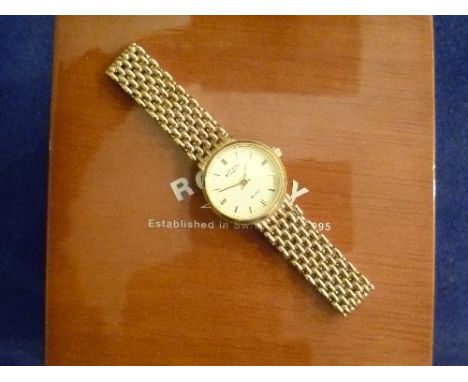 A 9ct gold Rotary Elite lady's Wristwatch, with circular dial and integral flexible 9ct gold gate-link bracelet, with present