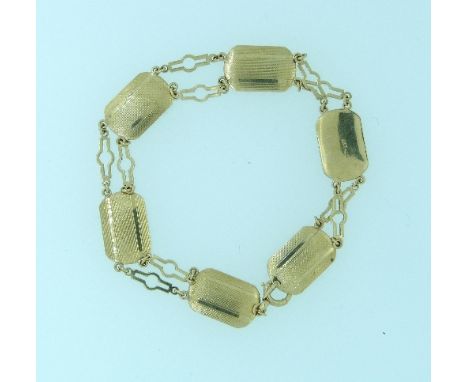 A 9ct yellow gold Bracelet, formed of six plaques, engine turned, with two rows of fine pierced links between, 6.3g.