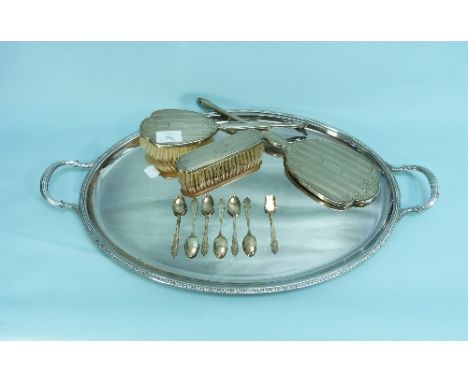 A three-piece silver-backed dressing table set, hallmarked Birmingham, 1964, comprising a hand mirror, hair and clothe brushe