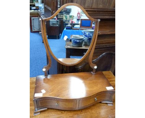 A Georgian mahogany shield shaped Dressing-table Mirror, on two drawer serpentine front base.