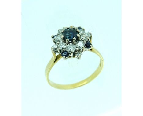 A sapphire and diamond cluster Ring, the centre with a circular sapphire surrounded by eight diamonds, with a further small d