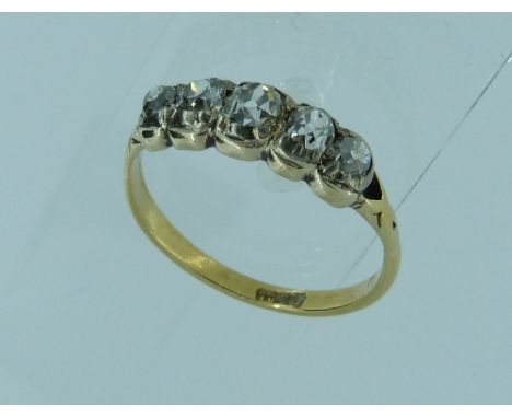 A graduated five stone old cut diamond Ring, with rubbed over settings, and open backed (centre stone c.¼ct, two x c.0.12ct, 