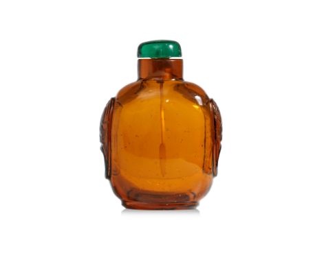 AN AMBER GLASS SNUFF BOTTLE Transparent amber glass in compressed ovoid form decorated in cut ring lug mounts to shoulders, w