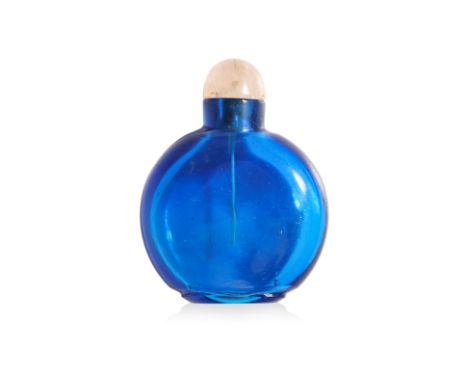 A LARGE SAPPHIRE-BLUE GLASS SNUFF BOTTLE Transparent glass in compressed circular form, standing on cut flat oval foot, rose 