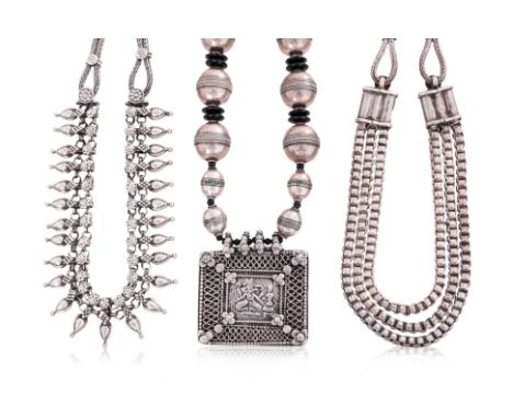 THREE INDIAN SILVER NECKLACES
One example with spherical beads and seed-like spacers, rectangular pendant depicting Bhairava;
