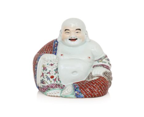 A FAMILLE ROSE PORCELAIN MODEL OF BUDAI 1st half 20th Century, modelled seated, holding a string of beads and a sack, the rob