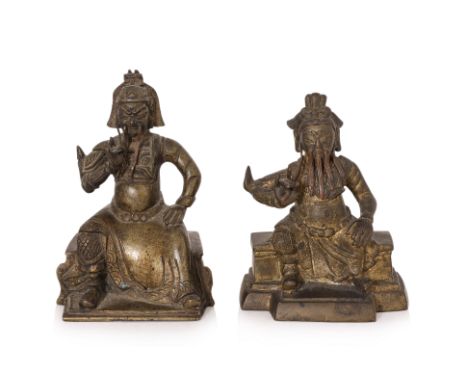 TWO BRONZE FIGURES OF GUANDI Both of a similar type, modelled seated wearing robe over armour, right hand stroking attached c