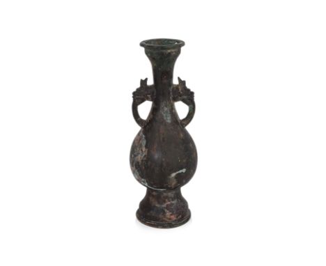 A BRONZE DRAGON-HANDLED HU-FORM VASE
Yuan style vase with rounded body and waisted neck, a pair of dragon handles, ridged mou