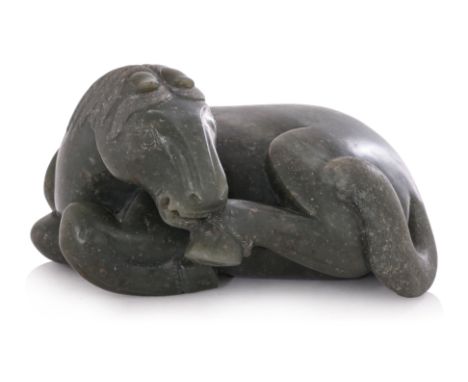 A JADE MODEL OF A RECUMBENT HORSE
Even-toned dark green jade modelled as a seated horse licking its hoof, fine incised detail
