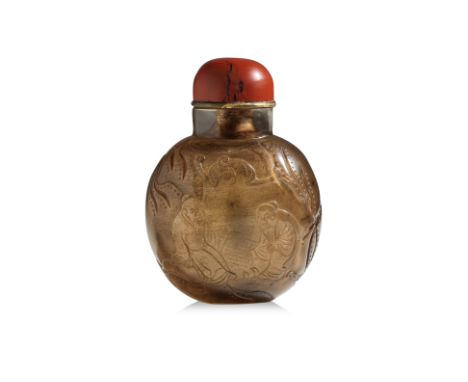 A CARVED SMOKY QUARTZ SNUFF BOTTLE
Of compressed spherical form decorated in continuous scene of two gentlemen playing board 