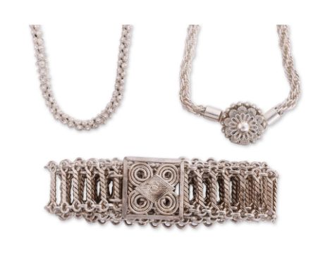A BELT AND TWO SILVER NECKLACES An articulated silver belt with square buckle; a rope-link belt with circular floret shaped b