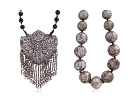 TWO SILVER NECKLACES
One example of spherical Chinese beads decorated in various flowers; the other with a large pendant of r
