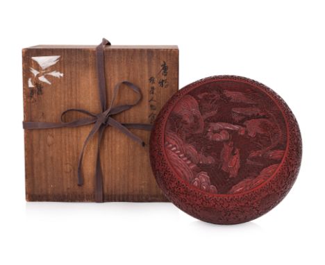 A CARVED CINNABAR CIRCULAR LACQUER BOX AND COVER Probably 19th/20th century, a tall circular box with flat cover, decorated i