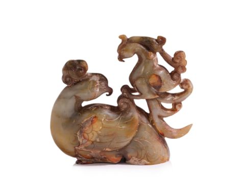 A CELADON AND RUSSET JADE CARVED MODEL OF TWO PHOENIX Modelled as a larger and smaller opposing perched phoenix, with a certi