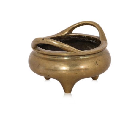 A POLISHED BRONZE TRIPOD CENSER Compressed circular form censer with two loop handles, with apocryphal Xuande mark to base, c