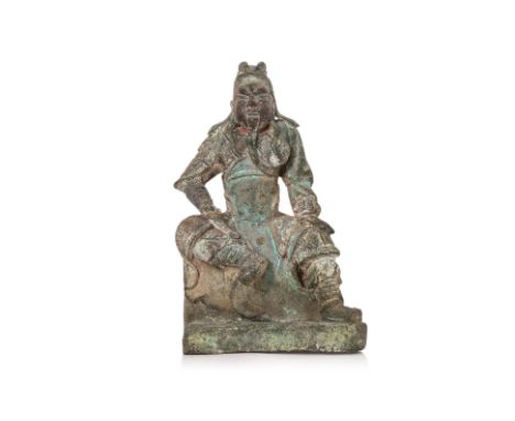 A SEATED BRONZE FIGURE OF GUANDI Heavily cast model, wearing armour and futou headdress, right hand in clenched fist and righ
