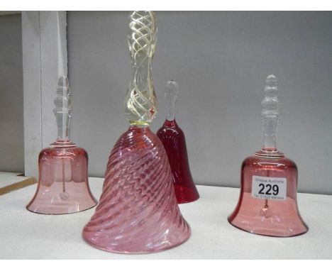 3 cranberry glass bells and a ruby glass bell