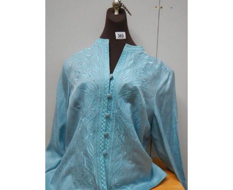 A shop display torso and a silk blouse