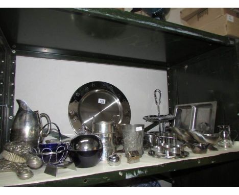 A shelf of metal ware