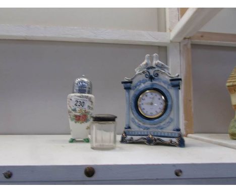 A silver topped pot, a sugar sifter and a ceramic clock