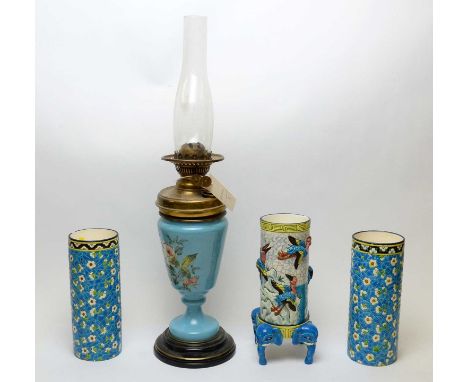 Brass oil lamp, the blue glass base painted with sprays of roses, on ebonised stepped circular base, 63cms high including fun
