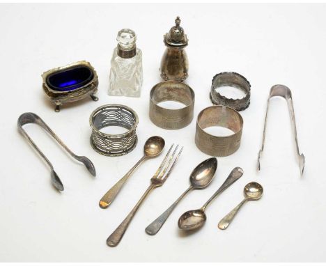 A selection of silver items, including: condiments; napkin rings; tongs; fork and other items. 